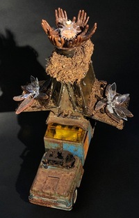 <div class='title'>Truckin'</div><br>flameworked vessel, eye and flowers,  cast wax hands, sheet glass,<br>toy truck, piano keys, vintage toaster, seed pods, moss, brass findings, found objects<br>20"h x 18"d x 17"w<br>NFS