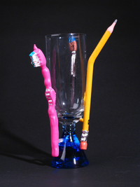 <div class='title'>Tools of the Trade</div><br>Flameworked glass tools, acrylics, glass cup with kiln-cast base <br>10"w x 6"h x 6"d<br>