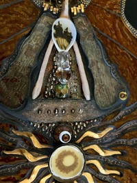 <div class='title'>Earth Wind Fire</div><br>cast (wishbone and hand) and flameworked (body, beads, flame) glass, sheet and stained glass, guitar, sea shells, sea urchins, metal findings<br>12"w x 40"h x 7"d<br>