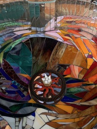 <div class='title'>Creation</div><br>flameworked eyes and white points on gear, cello, stained glass, mirror, piano keys, hand drill gear, grout<br>49"h x 21"w x 20"d<br>