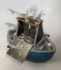 <div class='title'>Life Boat</div><br>Flameworked figures, hands and eyes, mirror, vintage toaster, artist-painted ceramic boat, metal chain, grout<br>17"h x 17"w x 17"d<br>